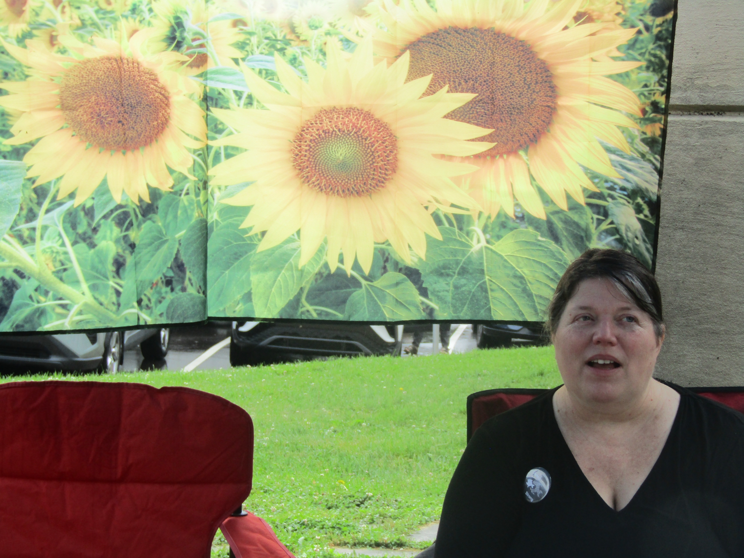 Image of Michelle Higgs with sunflower banner in background